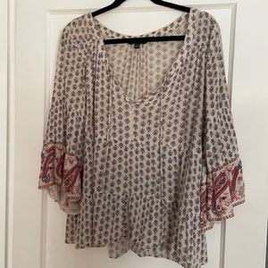 Three quarter sleeve v neck with tassel blouse. Light paisley pattern
